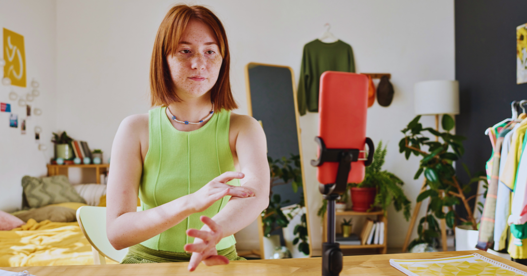Micro influencer recording product video for ecommerce brand using smartphone.