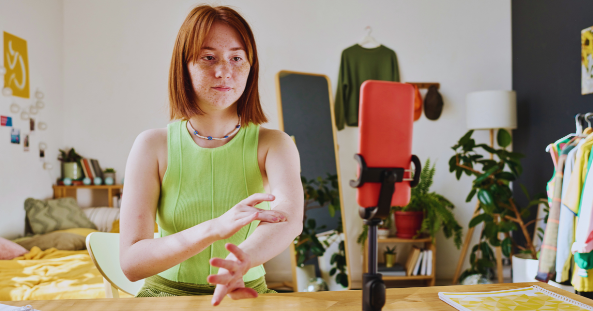 Micro influencer recording product video for ecommerce brand using smartphone.