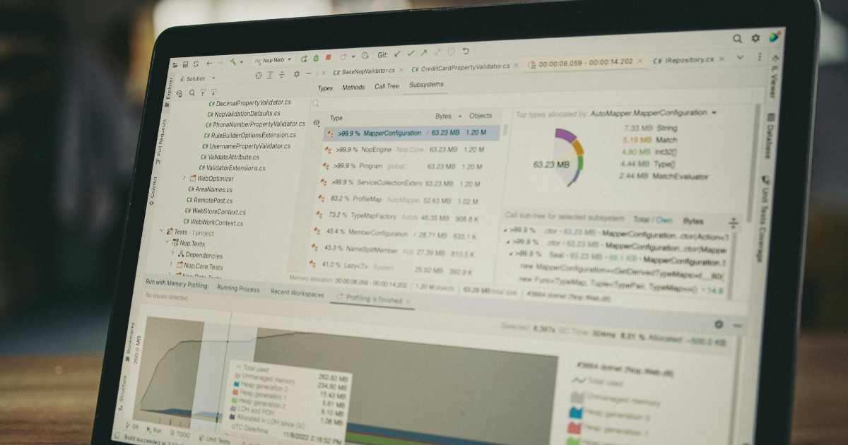 Laptop displaying performance data, diagnostic charts, and technical analysis.